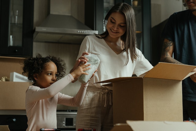 a family unpacking moving boxes